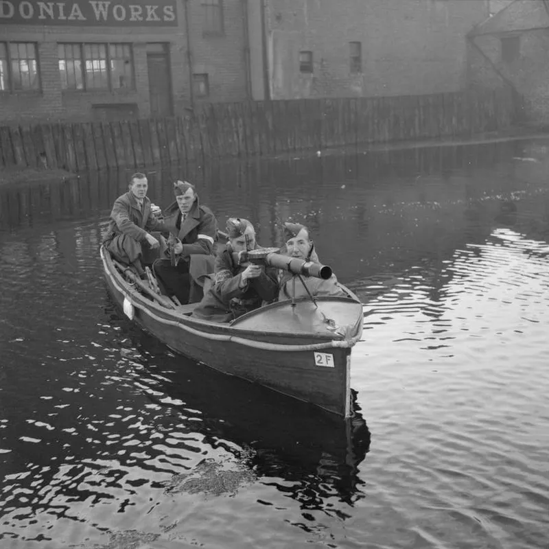 Home Guards patrol a canal in Edinburgh in a motor boat armed with rifles and a Lewis gun, October 1940
