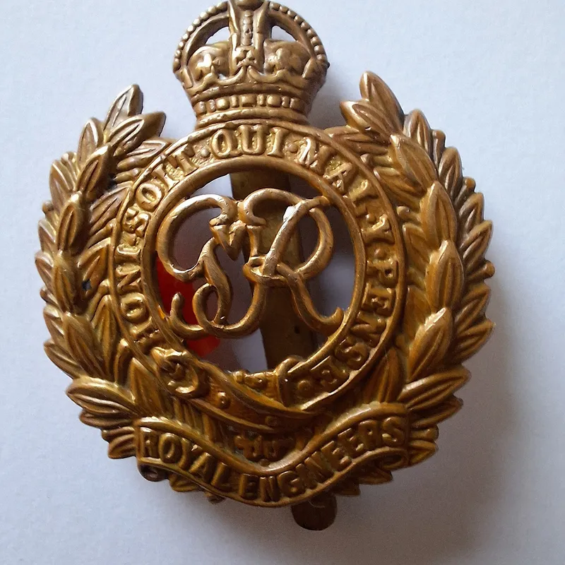 Royal Engineers cap badge with the royal cypher of King George VI