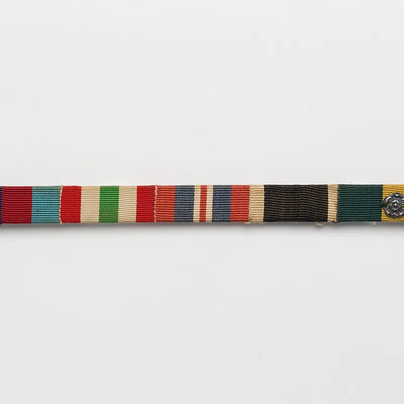 A Second World War medal ribbon bar including the 1939-45 Star, Italy Star and War Medal ribbons